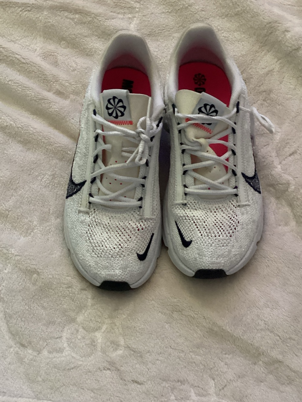 Nike White Flyknit Sneakers with Navy Swoosh and Pink Insoles